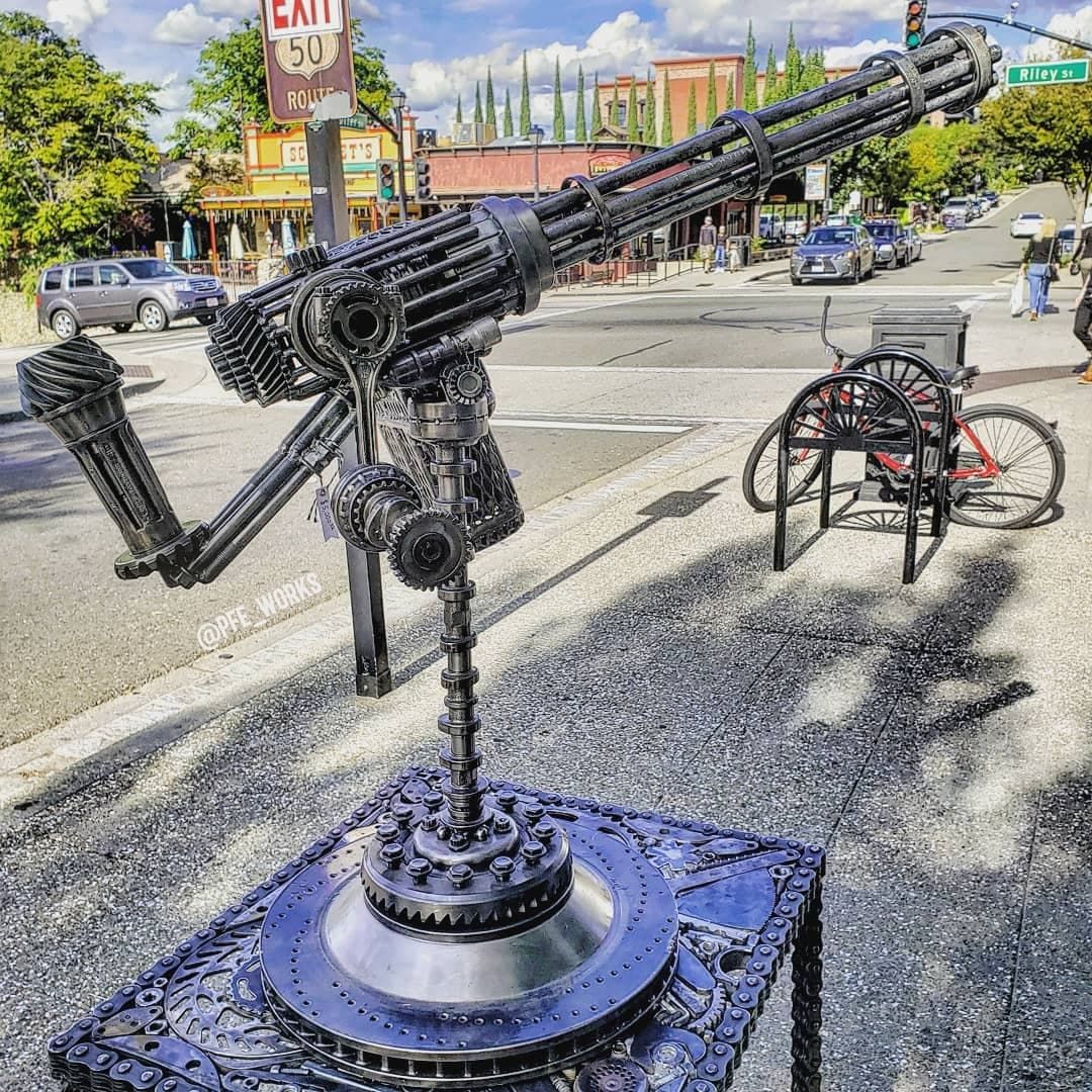 Scrap metal art sculpture of a gatling gun, created by metal artist PJ Kennedy aka PFe works