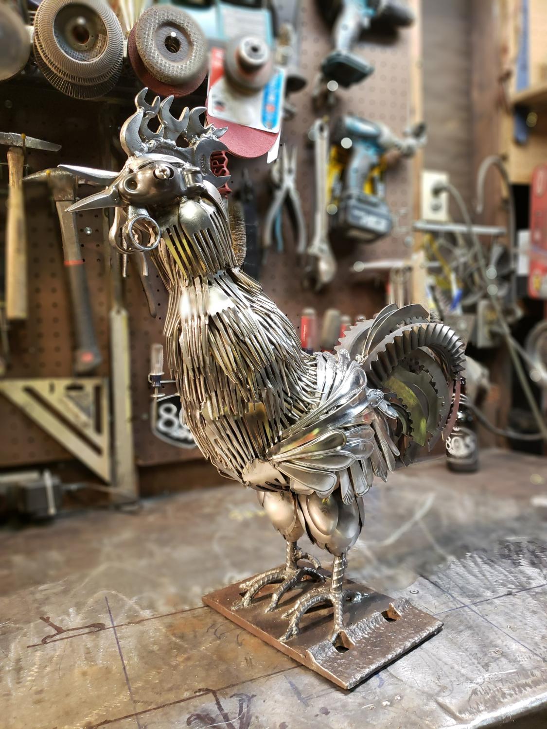 Weld art by metal artist PJ Kennedy aka PFe works, scrap metal rooster sculpture made of spoons, forks, and wrenches welded together